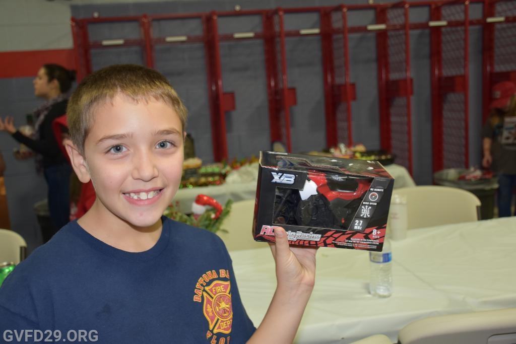 Brian Springer proudly displays the present that he received from Santa during the GVFD Holiday dinner