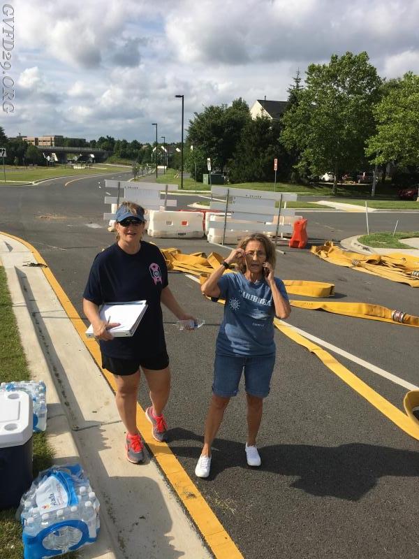 Admin members Cindy Brown and Cindy Jansen assist with hose testing.