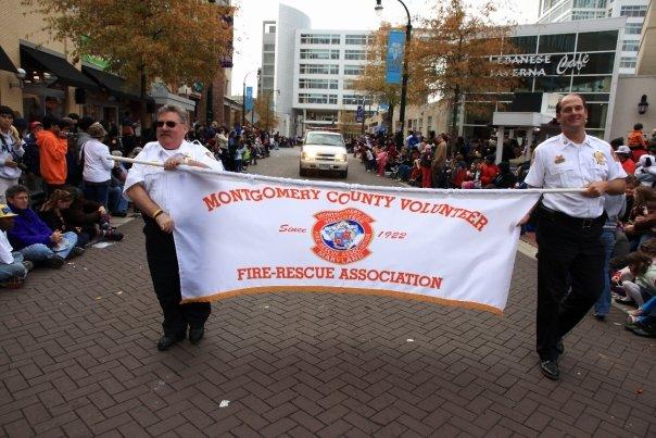 Chief Chornock and Executive Director Bernard proudly carry the MCVFRA Banner in the Silver Spring Thanksgiving Parade 