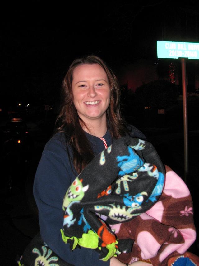 EMT Sarah Ogrin is smiling as she gets ready to present the blankets she made to the kids. 