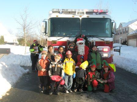 Santa poses with a group of kids during the Annual Santa Run 2009